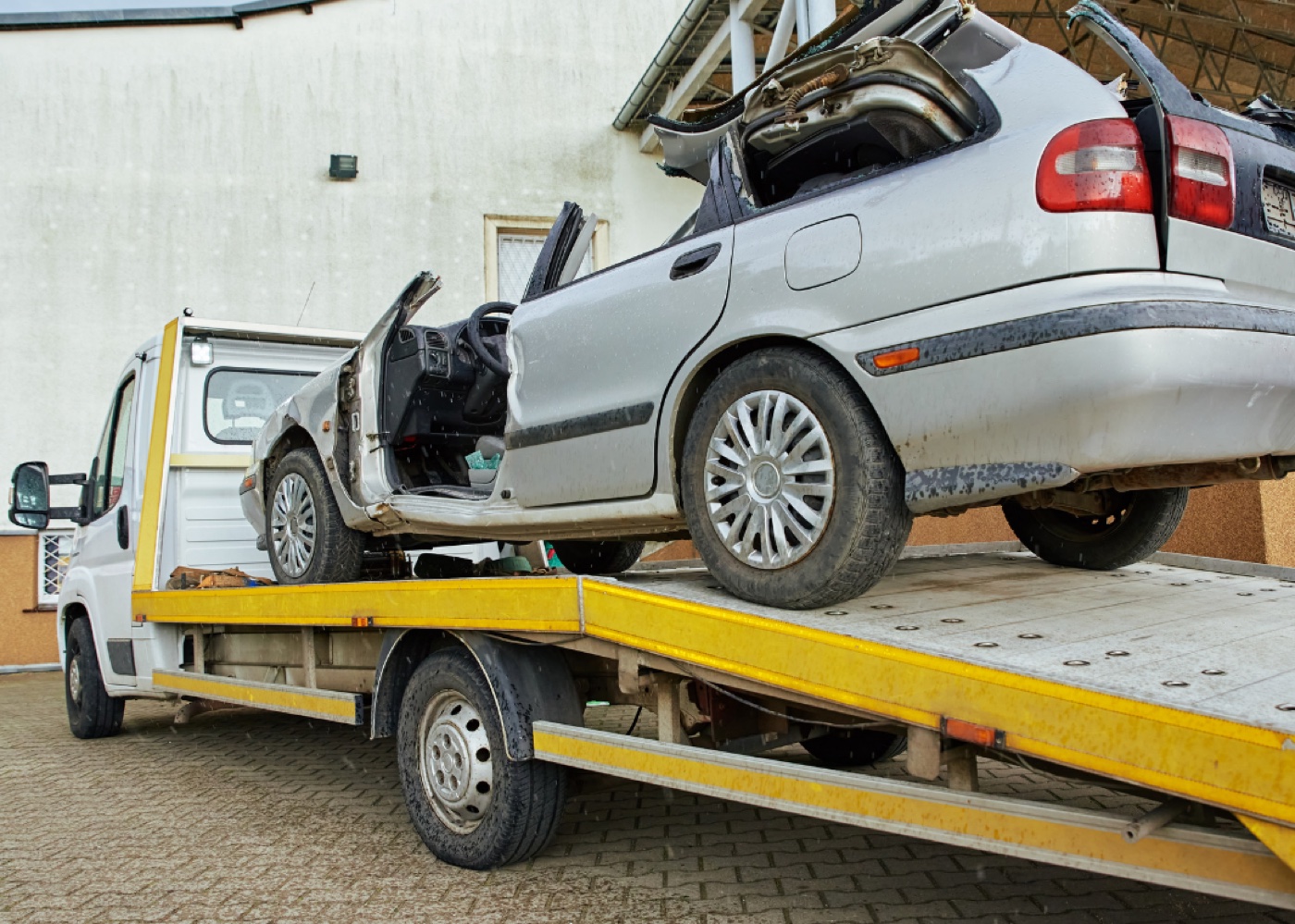 Damaged scrap vehicle on a flatbed
